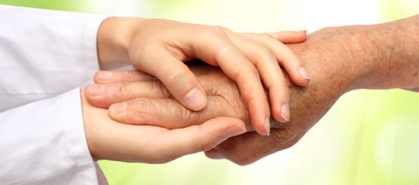 caregiver holding patient hand