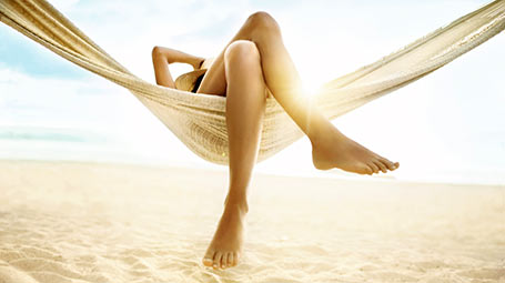 person in hammock on a beach